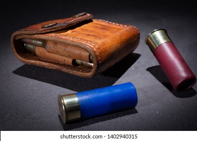 Bullet Case And Two Shotgun Cartridges Falling