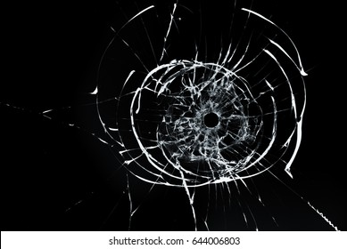 Bullet Hole In Glass Closeup On Black Background