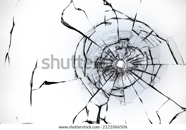 Bullet\
hole in the glass on a white background.\
Macro.