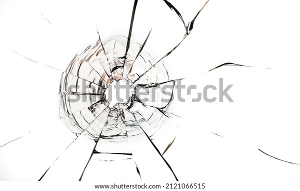 Bullet\
hole in the glass on a white background.\
Macro.