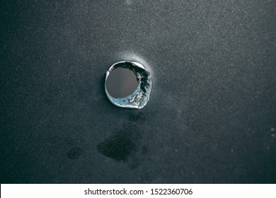 Bullet Hole On A Metal Sheet