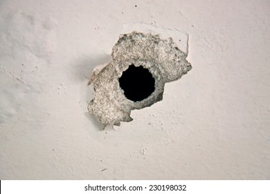 Bullet Hole On The White Wall