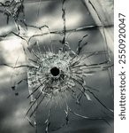 A bullet hole in the window of the house. Military and terrorist actions and the risk to the civilian population