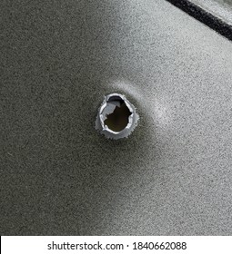 Bullet Holes In Aluminum Car Door Close Up