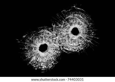 bullet holes in glass - authentic bullet holes closeup isolated on black