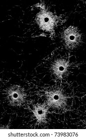 bullet holes in glass - authentic bullet holes from handgun - background or design element isolated on black
