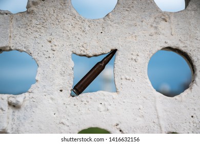 a bullet lodged in a wall