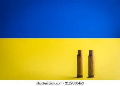 Bullet shells isolated on the Ukrainian flag background. Russia and Ukraine war concept. Stop war.