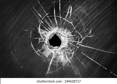 Bullet Shot Cracked Hole On Car Windshield Or Accident Damaged Broken House Window Glass 