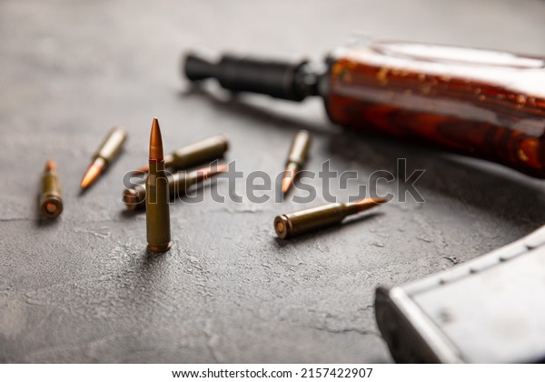 Bullets
and ammo magazine with kolashnikov assault rifle on black texture
marble.Composition with place for text.Rifle and carbine cartridges
on wooden background.Military concept.Copy
space
