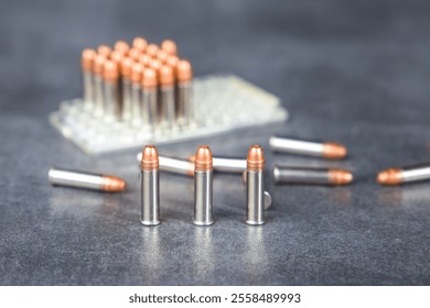 Bullets and blister pack on the table. Selective focus. Ammunition 22 lr for rifled weapons.
