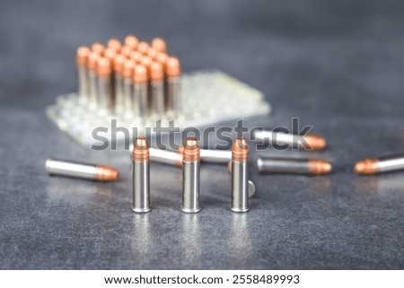 Bullets and blister pack on the table. Selective focus. Ammunition 22 lr for rifled weapons.
