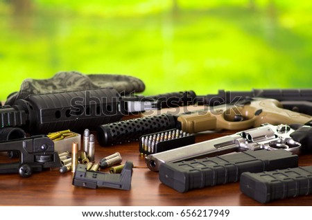 Bullets and a firearm. Bullets are a projectile expelled from the barrel of a firearm, on wooden table