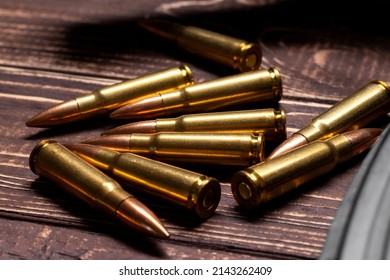 Bullets On Wooden Background. Cartridges 7.62 Caliber For Ak 47 Closeup. Selective Focus