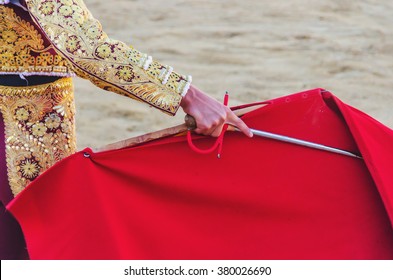 A bullfighter awaiting for the bull with his cape and sword. Corrida de toros