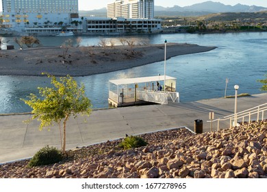 Bullhead, AZ / USA – February 19, 2020: Located in Bullhead City, Arizona, man waits at a dock for transport to the Nevada side of the Colorado River.