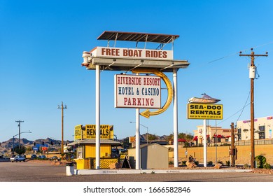 Bullhead City, AZ / USA – February 19, 2020: Remote parking lot in Bullhead City, AZ offering free boat ride across the Colorado River to the Riverside Resort Hotel and Casino in Laughlin, NV.  