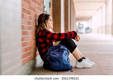 Bullied girl sitting alone at school