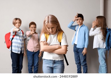 Bullied little girl and her classmates at school - Powered by Shutterstock