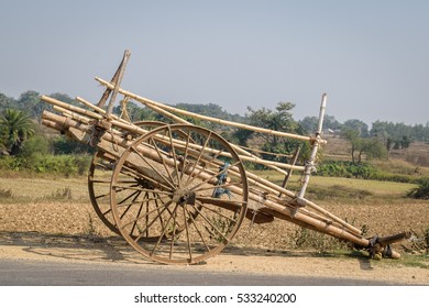 A bullock cart is standing on the road side.