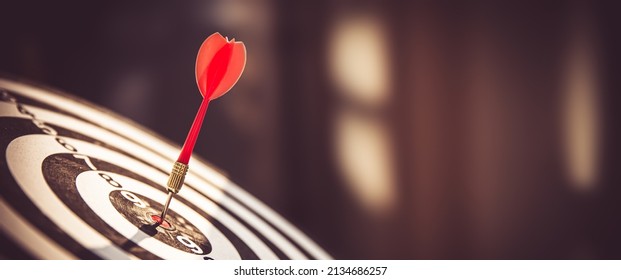 Bullseye or Bulls eye target or dartboard has dart arrow throw hitting the center of a shooting for financial business targeting planning and aim to winner goal of business concept. - Shutterstock ID 2134686257