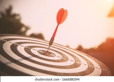 The bullseye, or bull's-eye or dart board has dart arrow hitting the center of a shooting target for business targeting and good success. - Shutterstock ID 1666080394