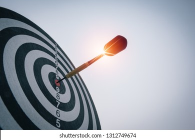 Bullseye is a target of business. Dart is an opportunity and Dartboard is the target and goal. So both of that represent a challenge in business marketing as concept. - Shutterstock ID 1312749674