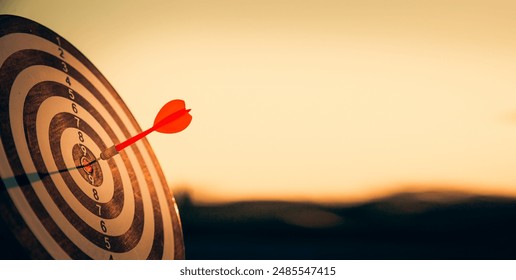 bullseye target or dart board has red dart arrow throw hitting the center of a shooting for business targeting and winning goals business concepts. - Powered by Shutterstock