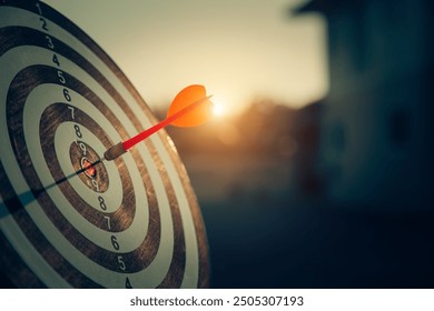 bullseye target or dart board has red dart arrow throw hitting the center of a shooting for business targeting and winning goals business concepts.