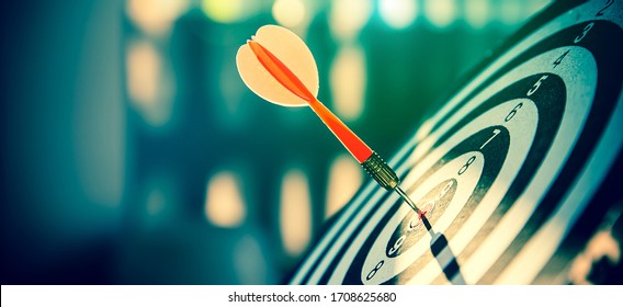 Bullseye(bull's-eye) or dart board has dart arrow hitting the center of a shooting target for business targeting and and  marketing goal concetps. - Shutterstock ID 1708625680