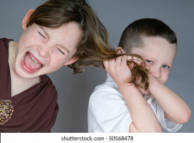 Bully boy pulling girl's hair
