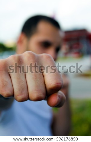 Bully throwing a punch towards the camera with fists clenched