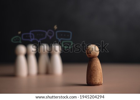 Bullying and Racist Concept. World Social Issue. Sad Person being Bullied from others. Parody and Intimidation. Doing or Saying Bad. presenting by wooden peg dolls