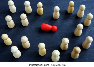 Bullying, workplace harass and loneliness concept. Wooden figurines on a desk. - Powered by Shutterstock