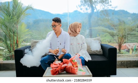 Bumijawa , Indonesia - May 22 , 2022
Couple Photo In All White Clothes On Cafe Sofa