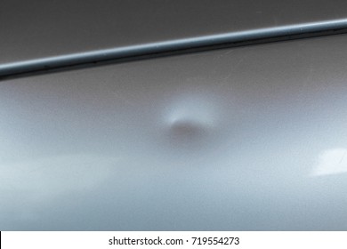 Bump On Car With Silver Paint.