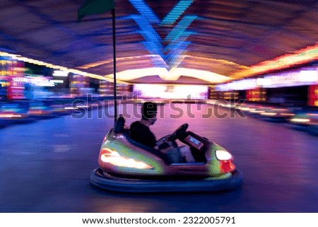 A bumper car takes center stage amidst the lively atmosphere of a fair, ready to provide thrilling and fun-filled rides for all.