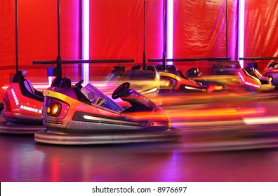 Bumper cars in motion in amusement park