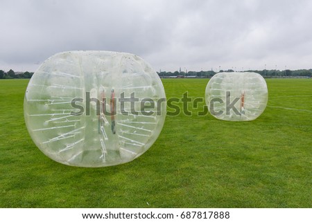 Bumper-balls for soccer playing on a green lawn, a new funsport in Copenhagen, Denmark - July 27, 2017