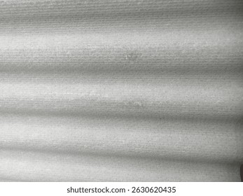 Bumpy asbestos surface. Repeated up and down patterns
