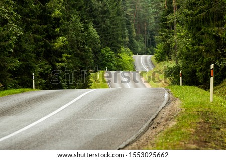 Bumpy curvy road surrounded by Labanoras forest in Lithuania