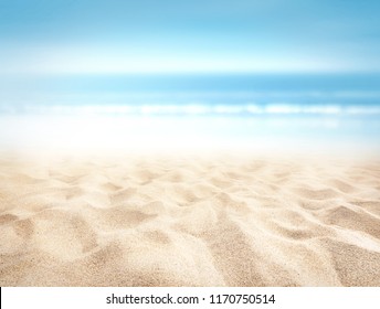 Bumpy tropical sandy beach with blurry blue ocean and sky - Powered by Shutterstock