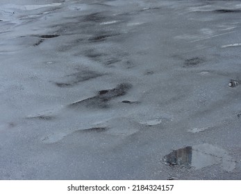 Bumpy Wet Asphalt Road After Rain