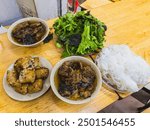 Bun cha is a famous Vietnamese noodle dish with grilled pork served with fresh herbs, on a bamboo base. US President, Obama tried this dish in Hanoi when visiting the Vietnamese capital in 2016.