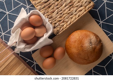 Bun With Eggs On A Background With A Blue Tea Towel With White Stripes.