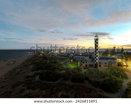Bunbury Lighthouse with the Marlston Hill Lookout on the background at sunrise.