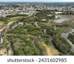 Bunburys Big Swamp reserve, Tuart St on left and South Bunbury suburb in the background. Drone image in summer with partially empty lake (view south).