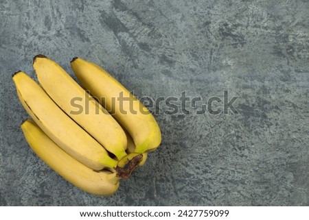 Bunch of bananas on a biton background. Top view