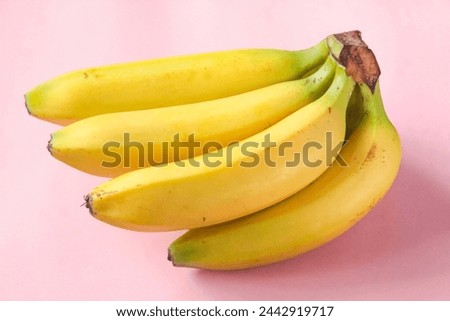 bunch of bananas on a pink background