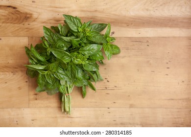 Bunch Of Basil Isolated On Wood Background